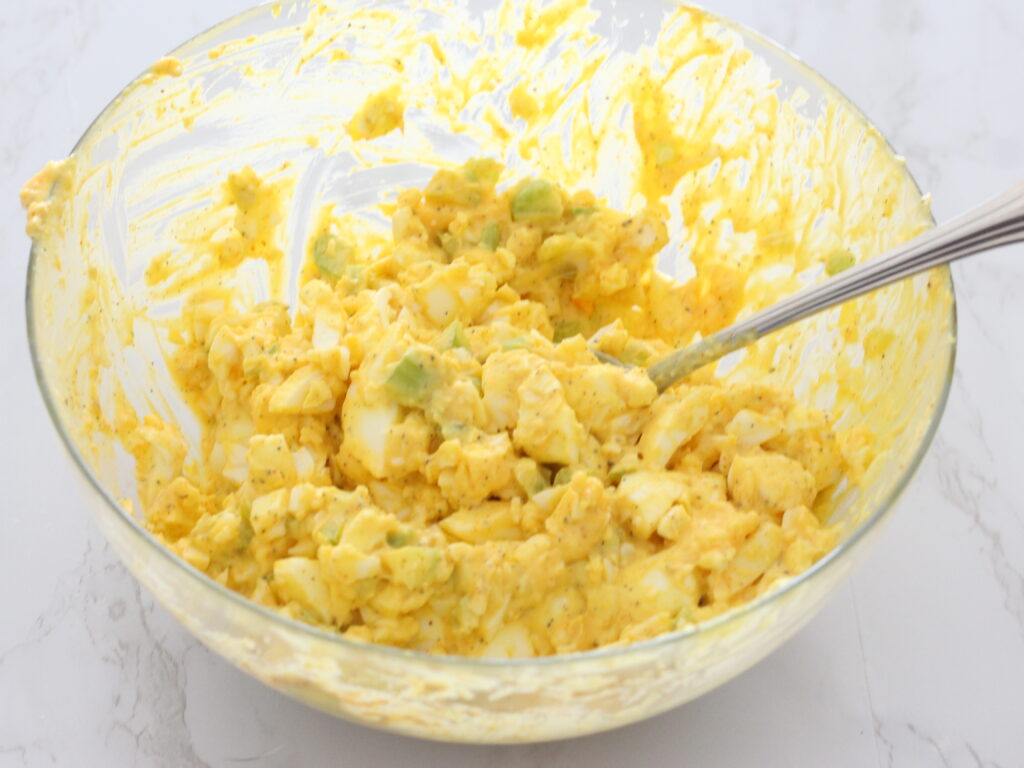 creamy Egg salad in a bowl with a spoon