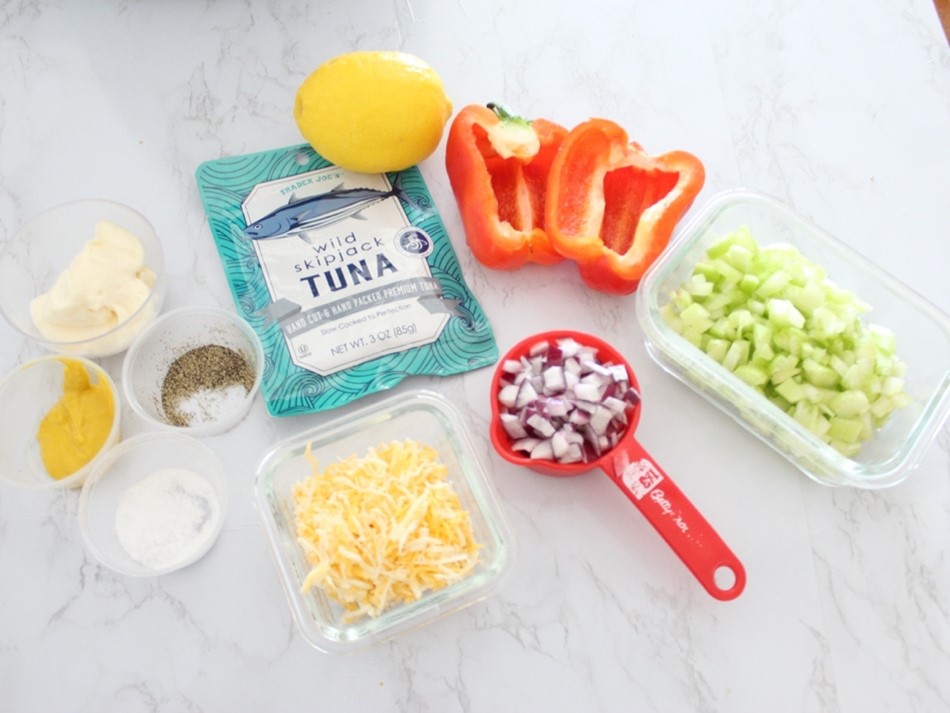 Ingredients for tuna salad on a red bell pepper. 