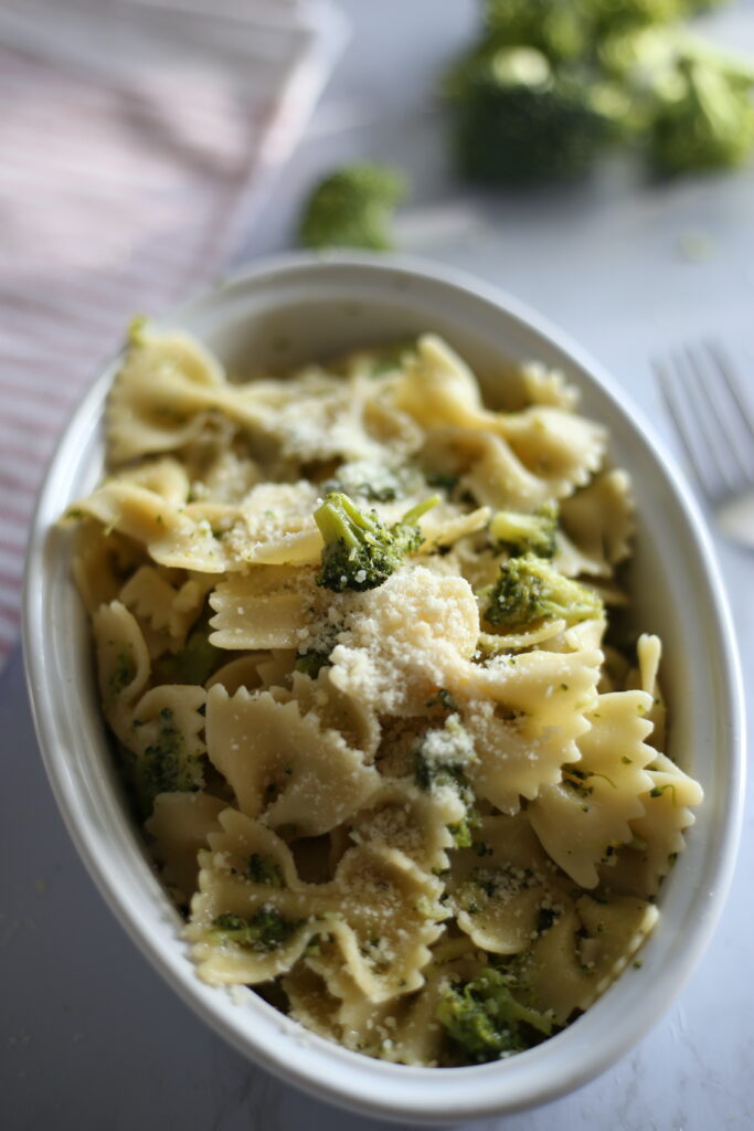 bow tie pasta and broccoli in an oval bowl