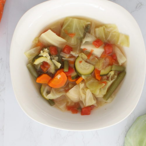 Cabbage soup in a white bowl