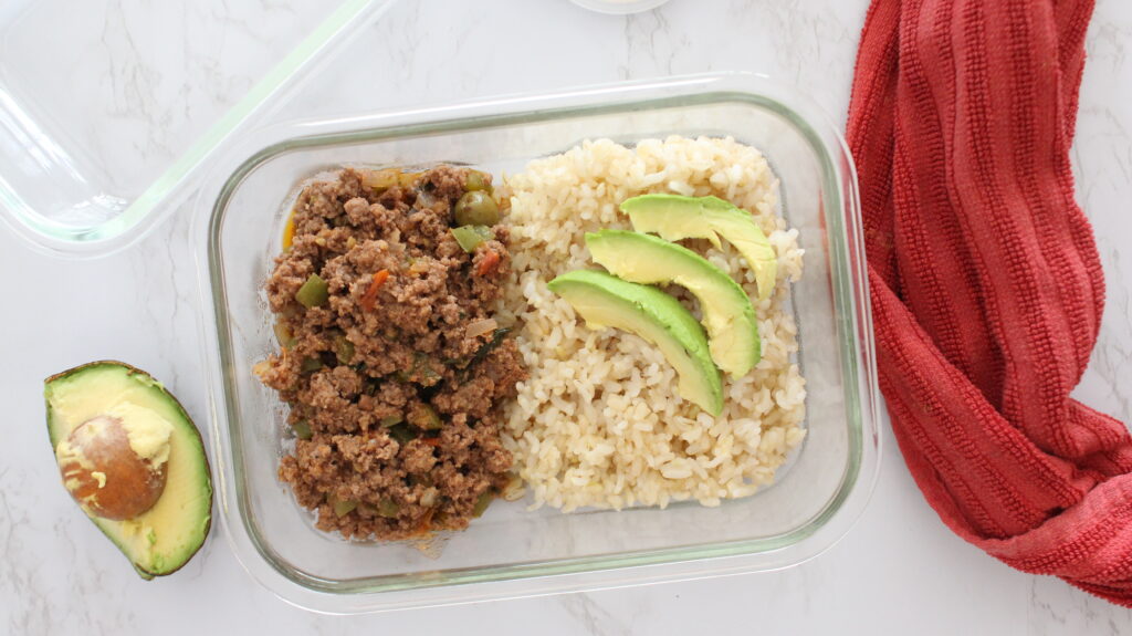 ground beef with brown rice and avocado in a glass container 