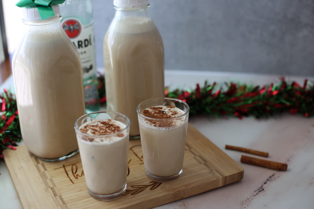 Puerto Rican eggnog in glass cups on a cutting board.