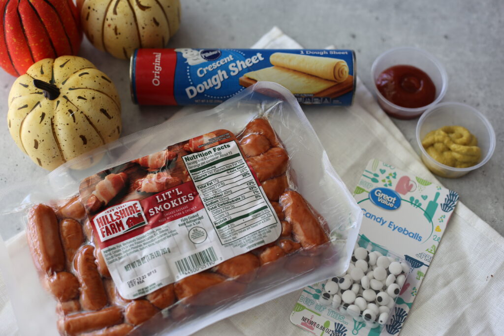 ingredients laid out on a table with a white cloth for mummy dogs.