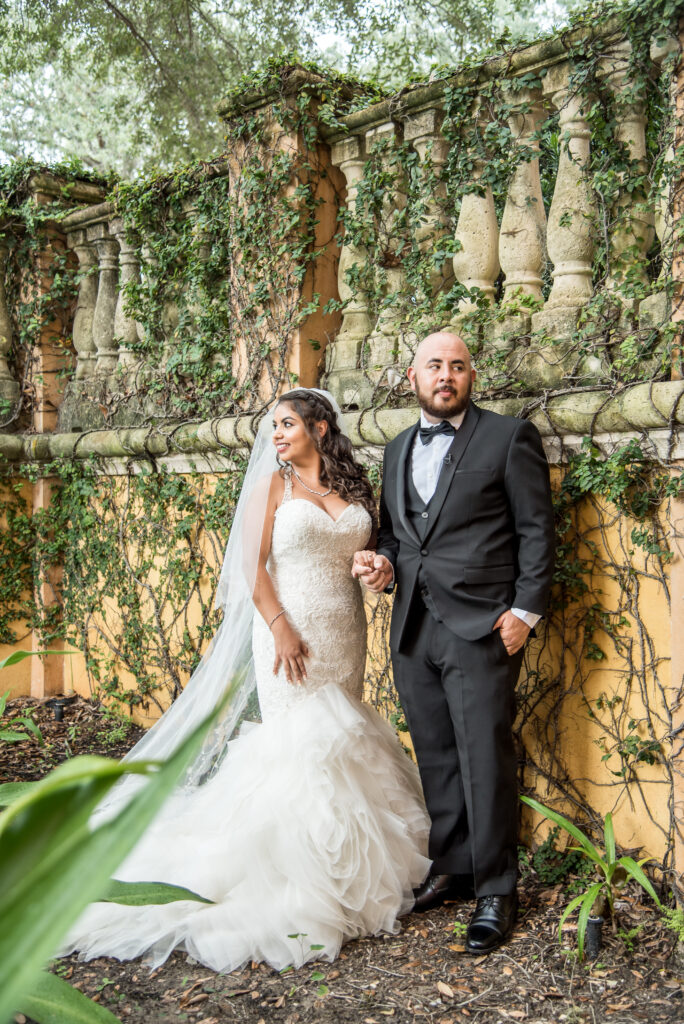 bride and groom with vines in the background 