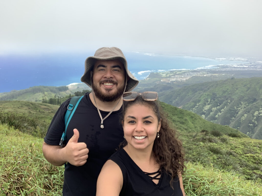 a couple hiking in maui with a view