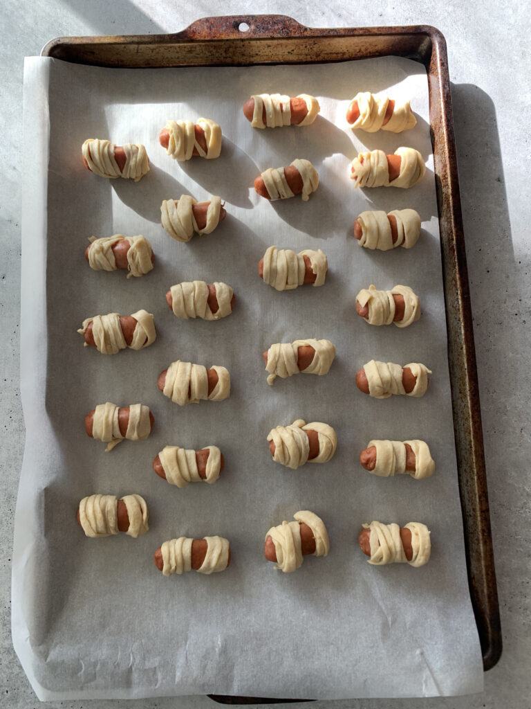 pigs in a blanket on a baking sheet